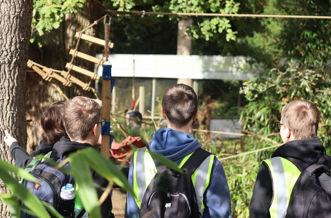teenagers look across lemur enclosure