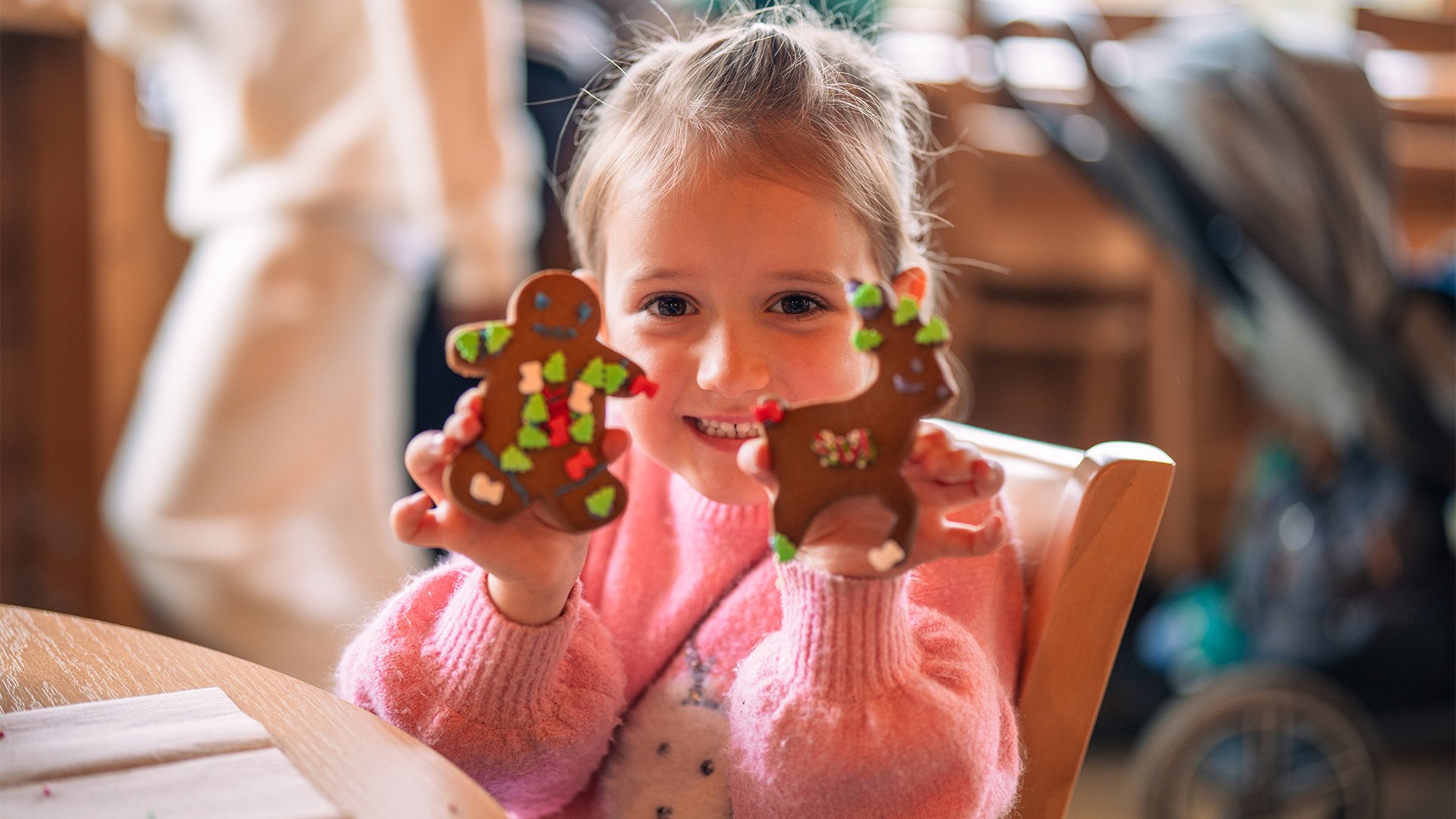 Young girl showing her decorated festive biscuits 
