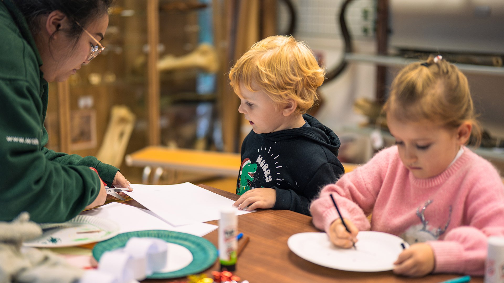 Education ranger with young children during Christmas crafts