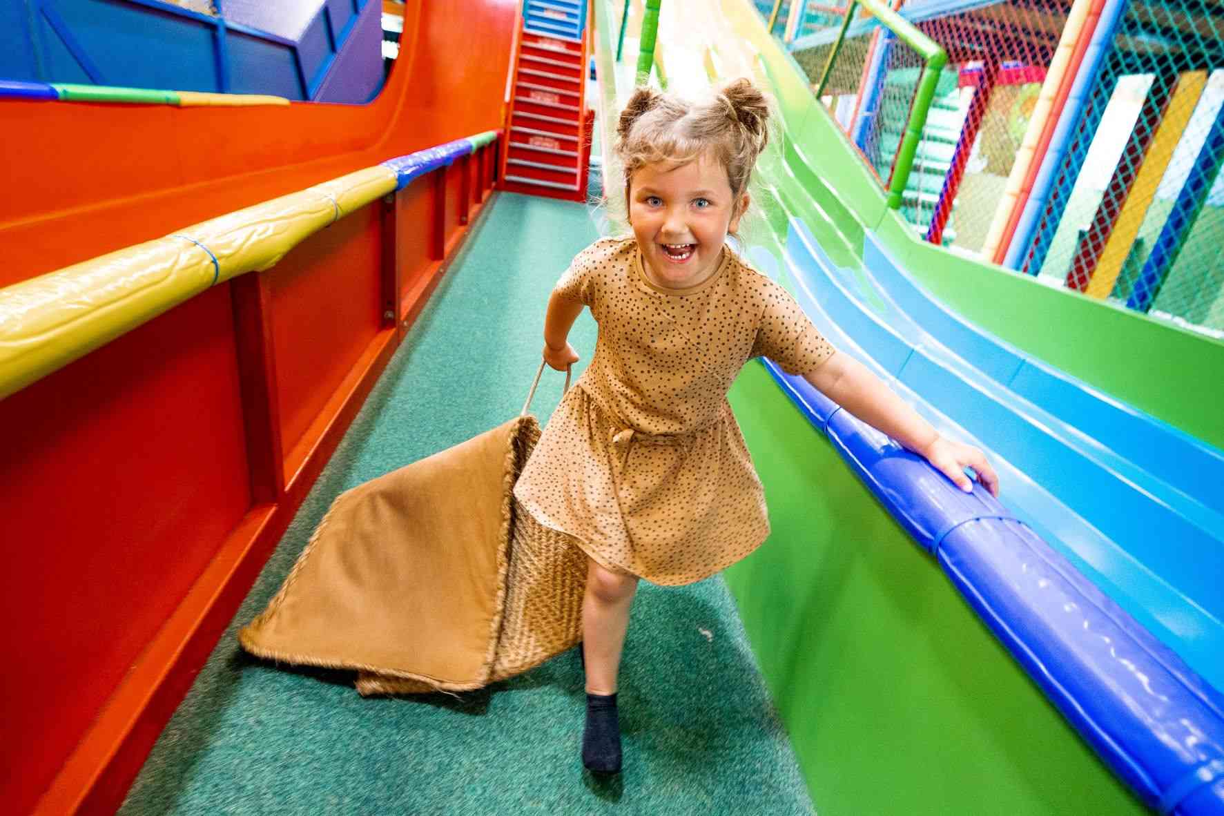 Child on giant slide in Mammoth Play Ark.jpg