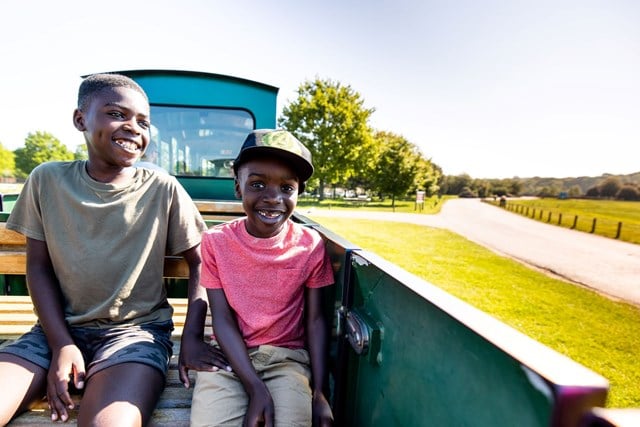 Two children enjoy a train ride through safari park
