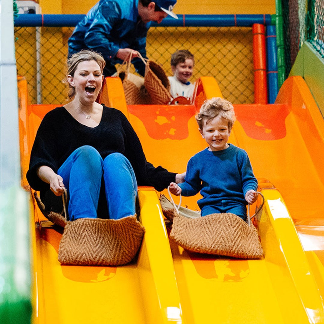A mother and son using the slide at the Mammoth Play Ark at Woburn Safari Park